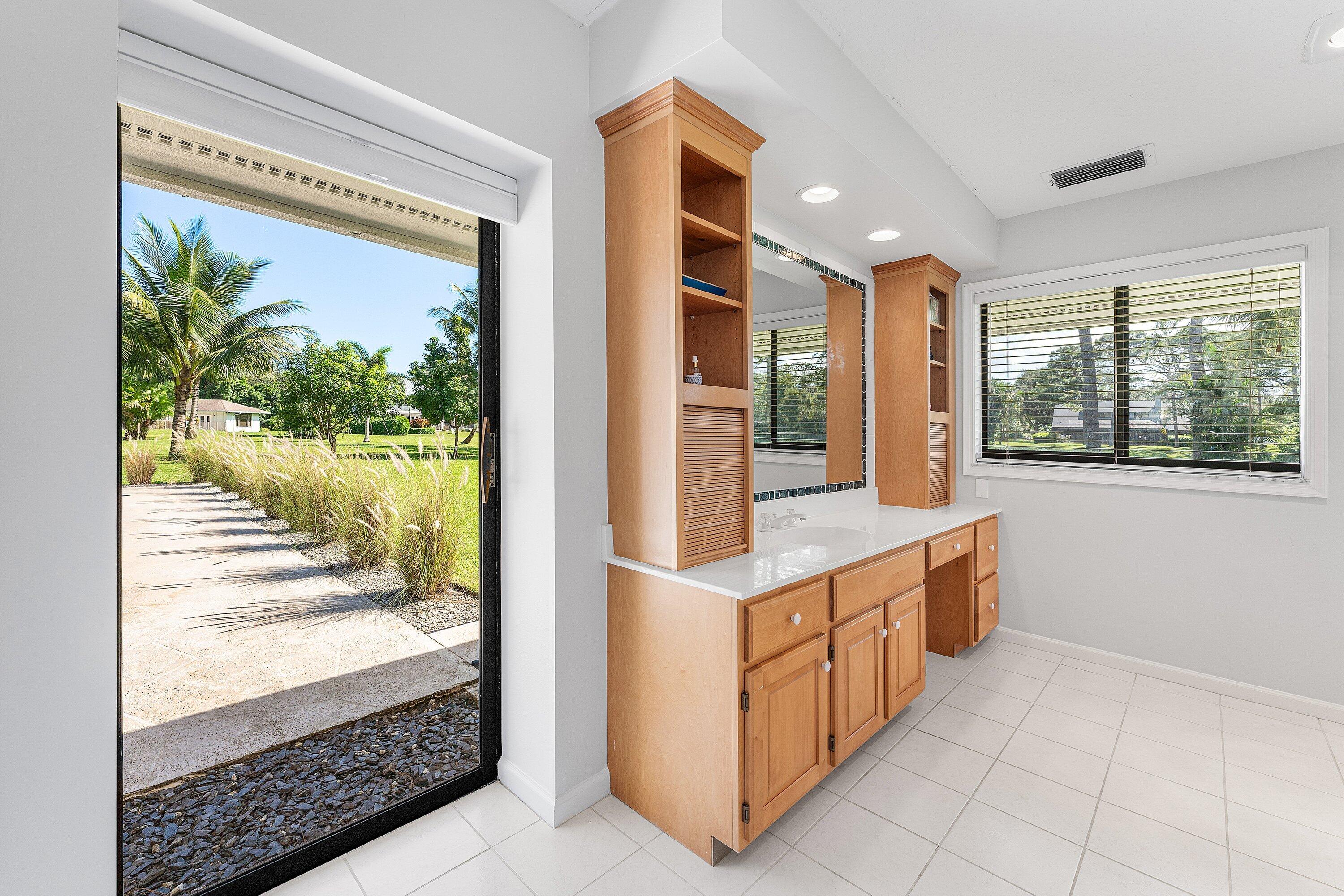 6048 Wood Lake Road Jupiter, FL 33458 - Photo 13 of 31 a kitchen with granite countertop a stove and a wooden floor