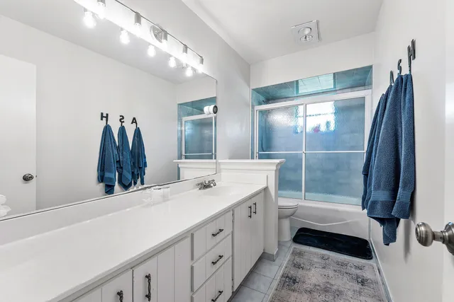 a bathroom with a double vanity sink and a mirror