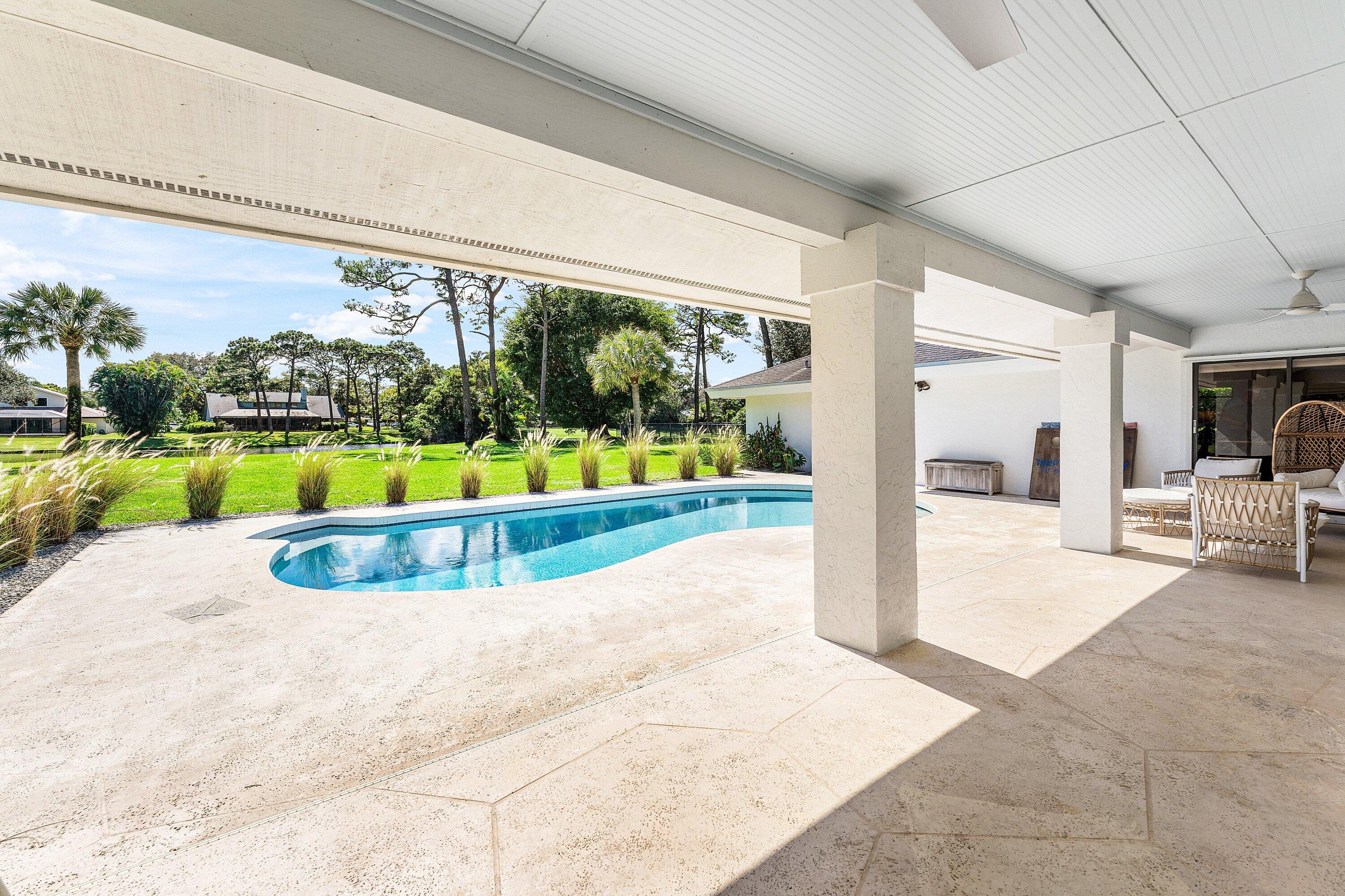 6048 Wood Lake Road Jupiter, FL 33458 - Photo 22 of 31 a view of a swimming pool and a porch