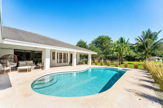 an aerial view of a house with a yard and garden