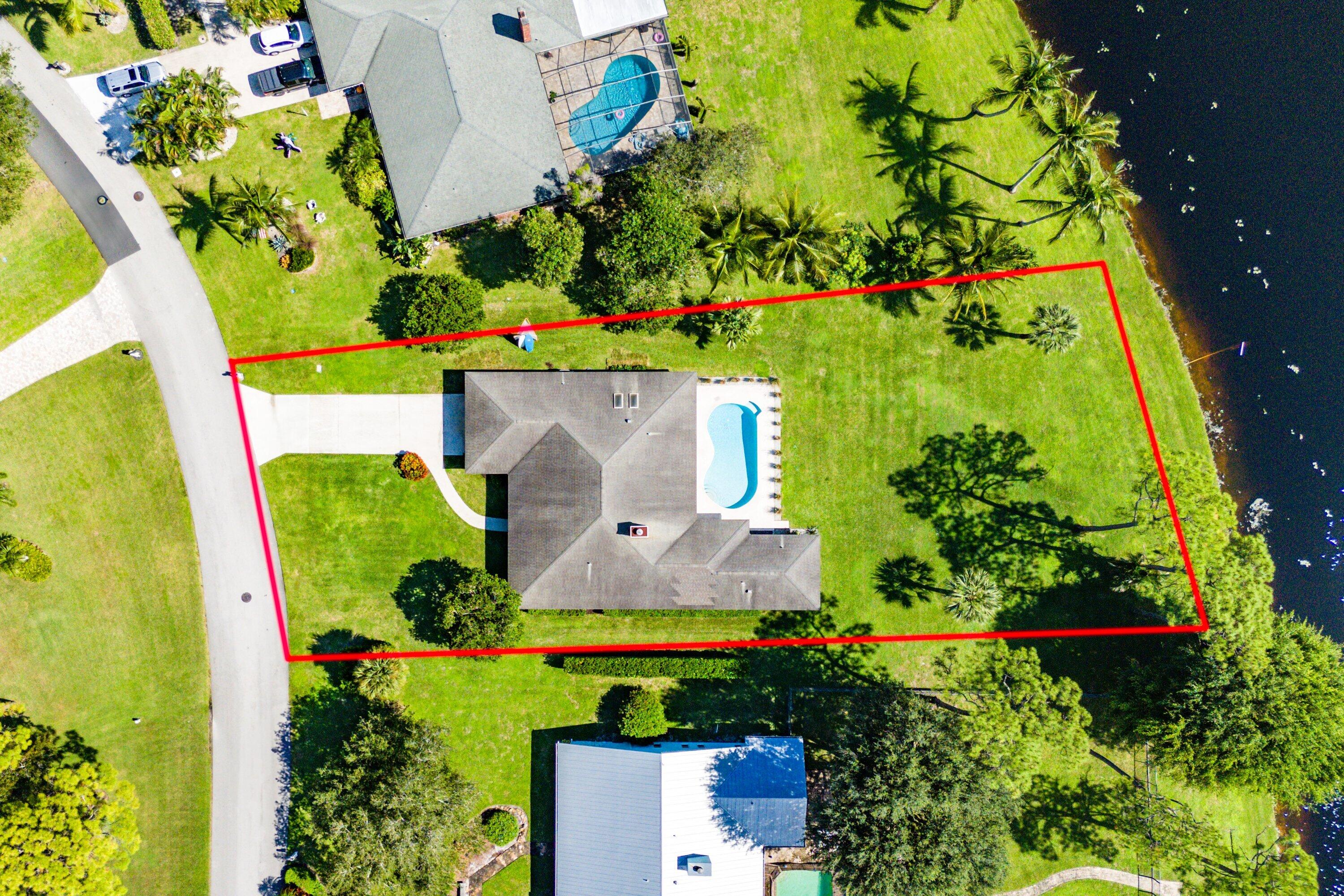 6048 Wood Lake Road Jupiter, FL 33458 - Photo 25 of 31 an aerial view of a house with a yard and garden