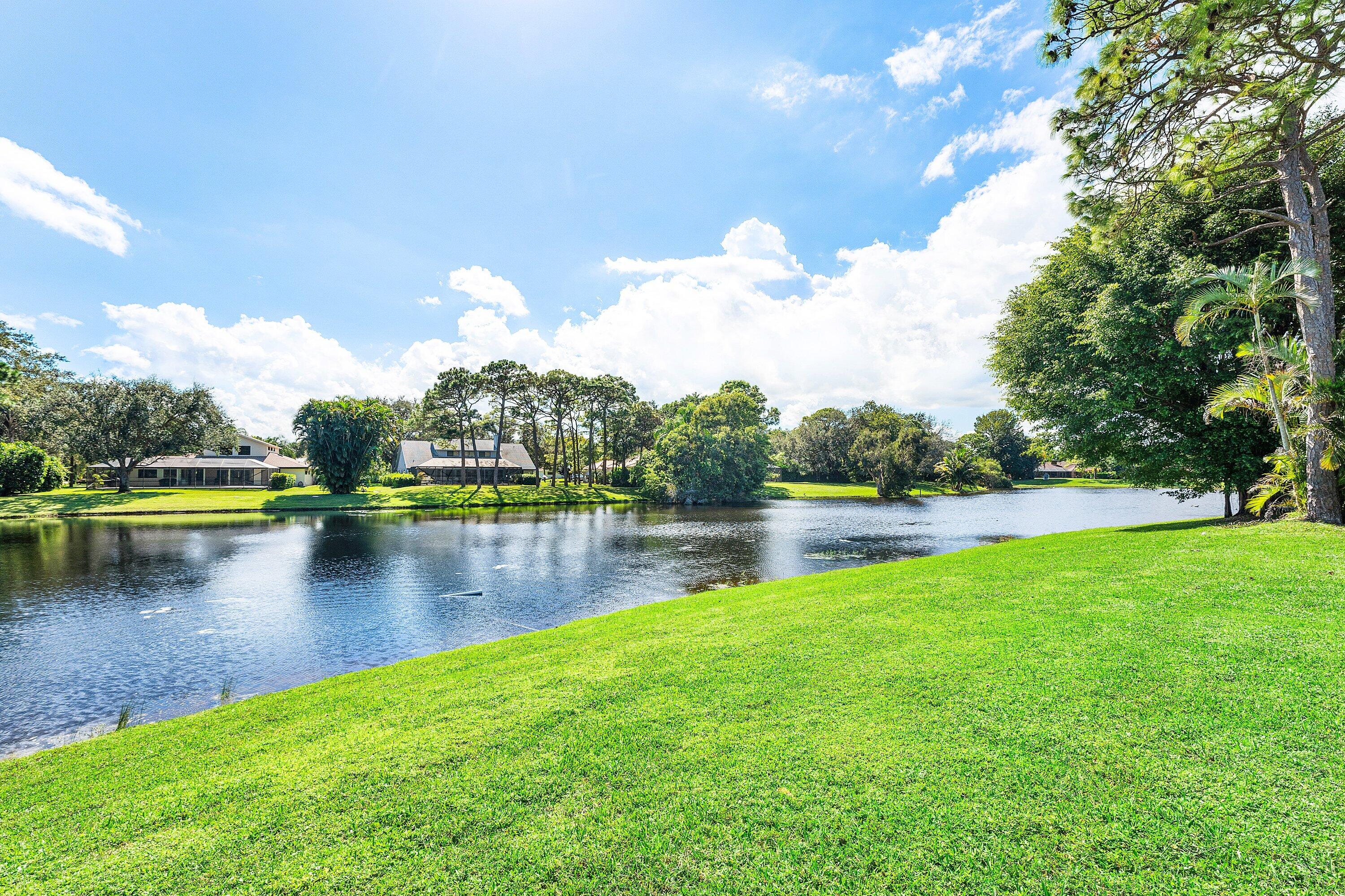 6048 Wood Lake Road Jupiter, FL 33458 - Photo 28 of 31 a view of a lake with houses in the background