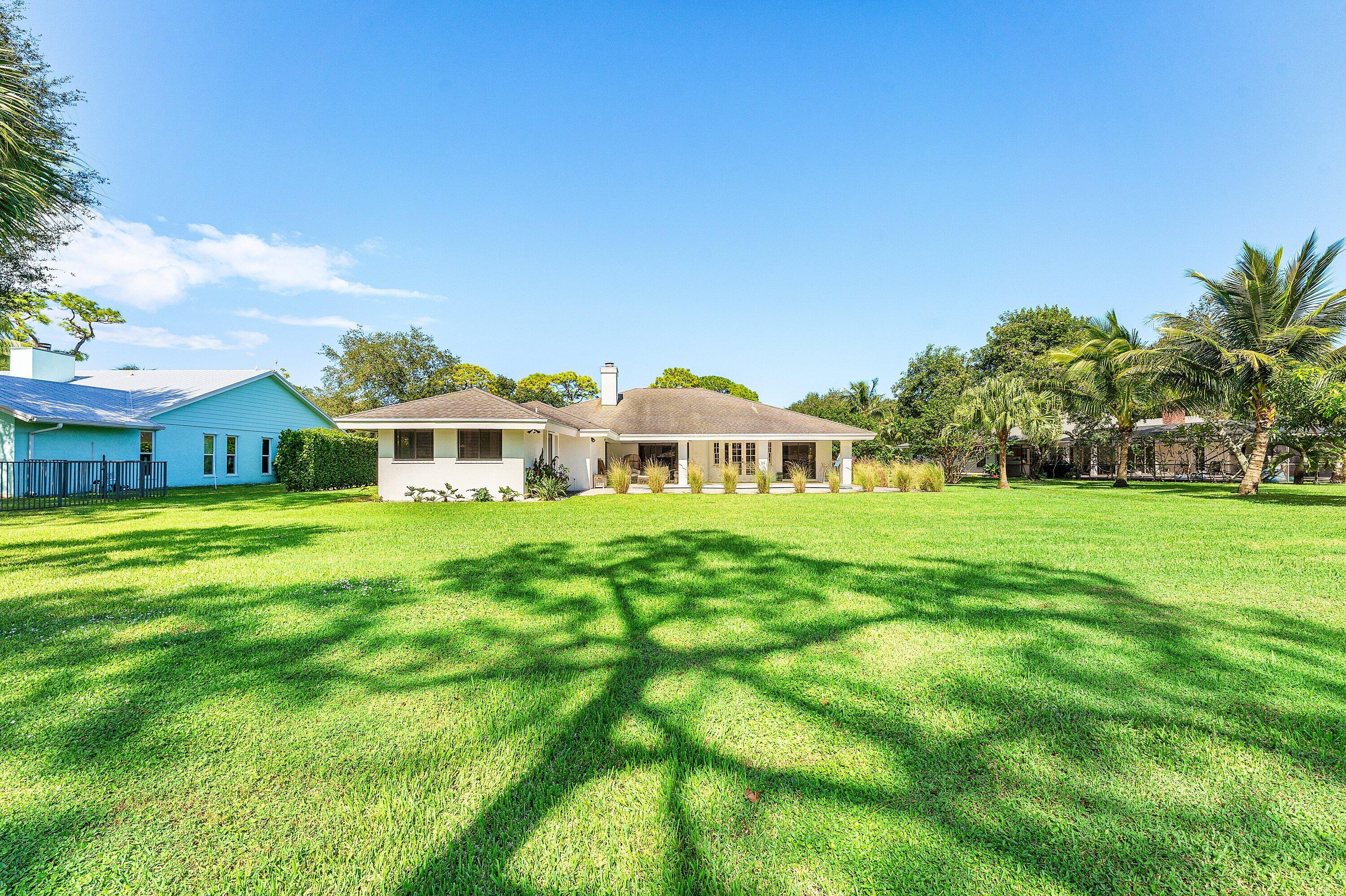 6048 Wood Lake Road Jupiter, FL 33458 - Photo 29 of 31 a front view of house with yard and green space