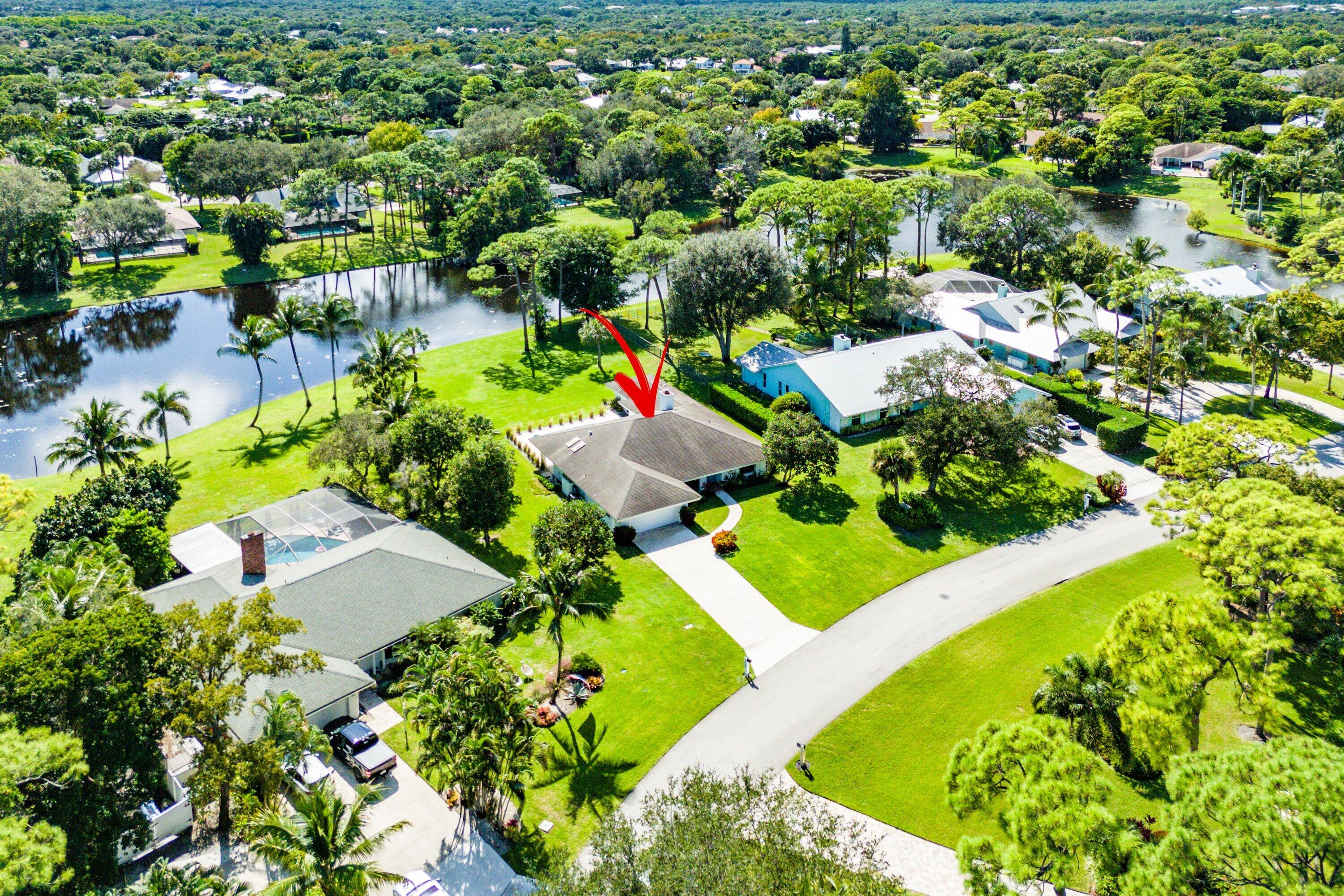 6048 Wood Lake Road Jupiter, FL 33458 - Photo 30 of 31 an aerial view of residential houses with outdoor space and trees all around