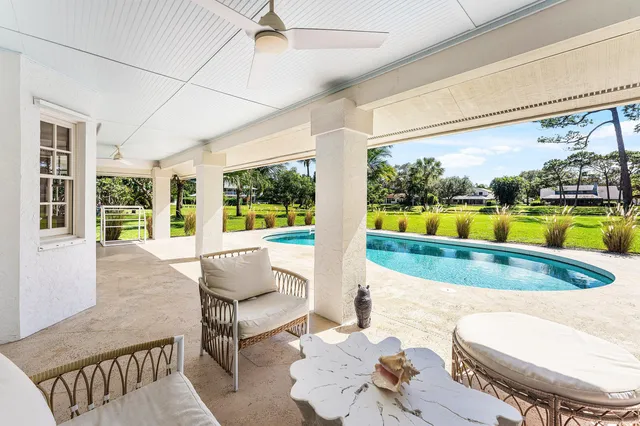 a view of a dining room with furniture a chandelier and wooden floor