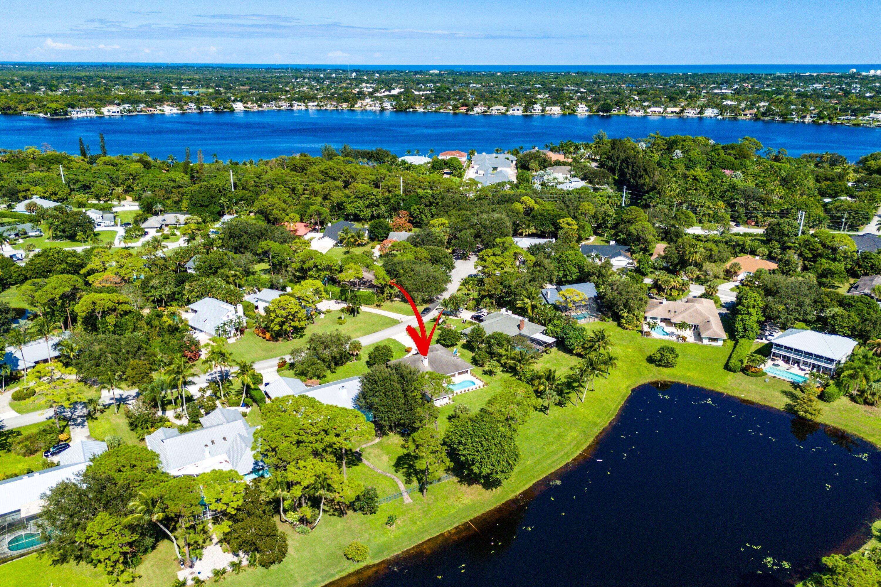 6048 Wood Lake Road Jupiter, FL 33458 - Photo 31 of 31 a view of a lake with a building in the background
