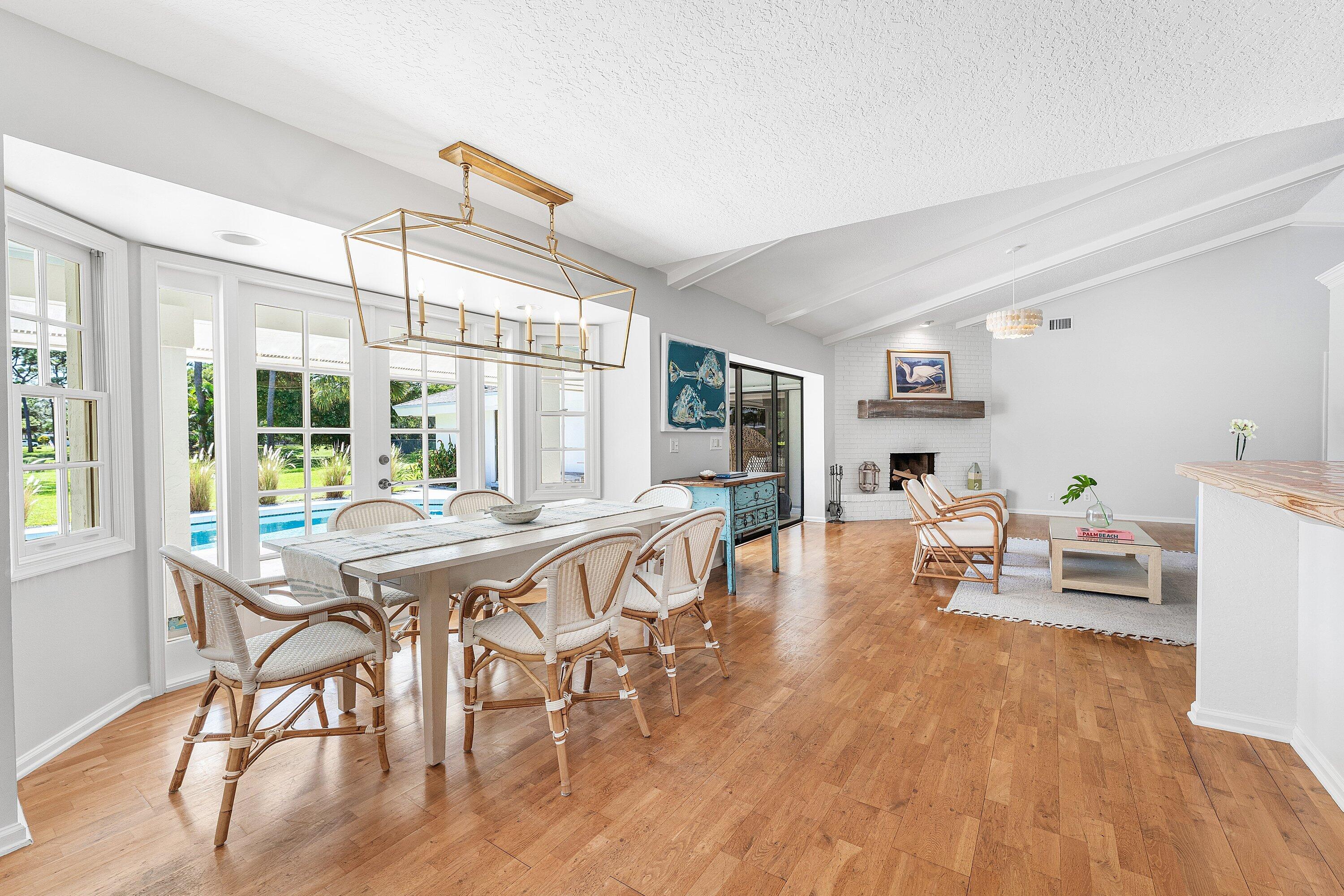 6048 Wood Lake Road Jupiter, FL 33458 - Photo 5 of 31 a view of a dining room with furniture window and wooden floor