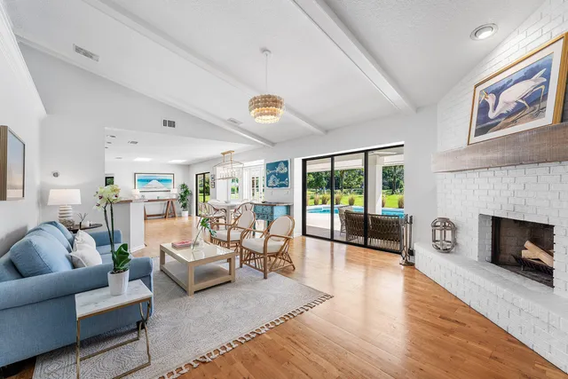 a living room with furniture large window and a fireplace