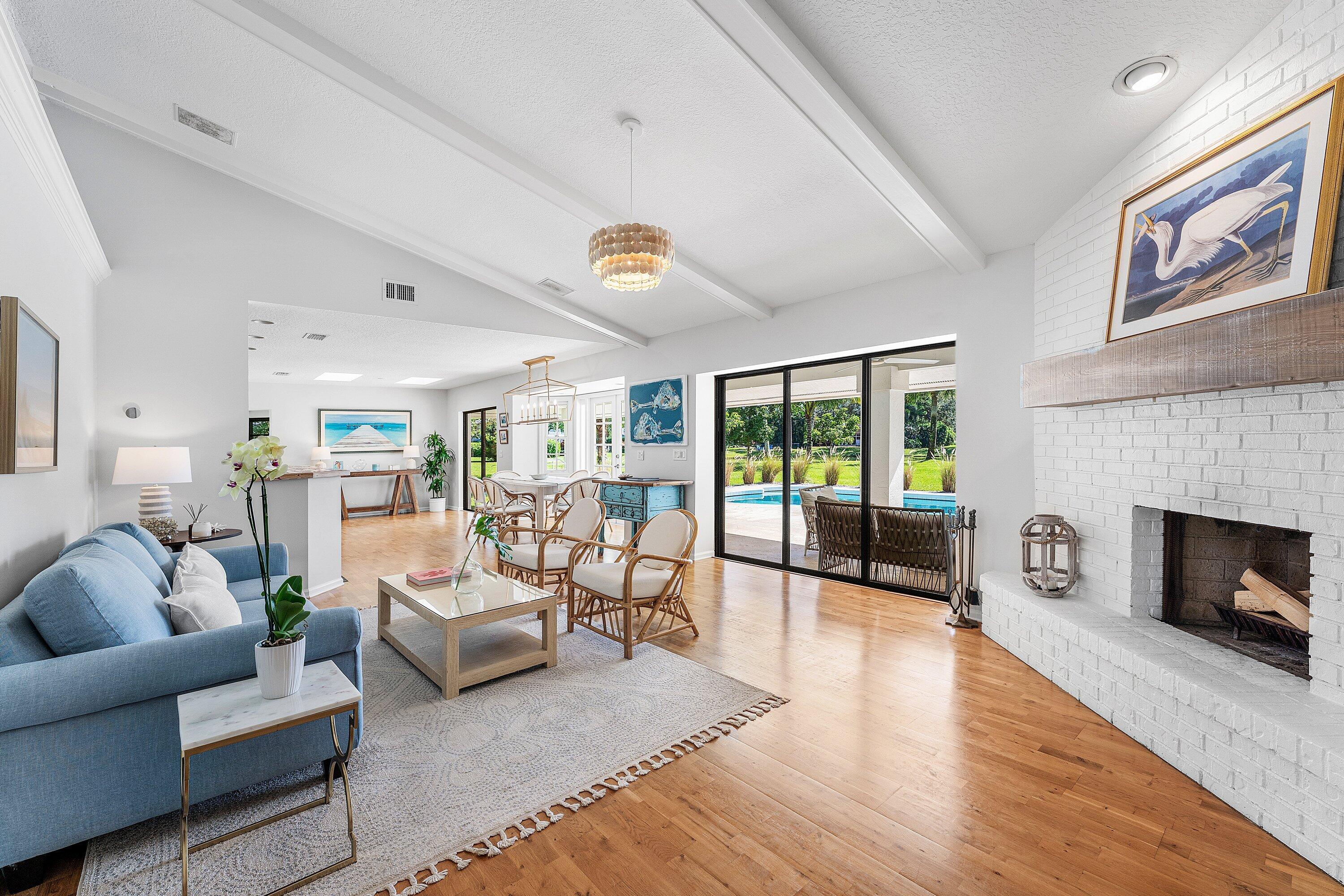 6048 Wood Lake Road Jupiter, FL 33458 - Photo 7 of 31 a living room with furniture large window and a fireplace