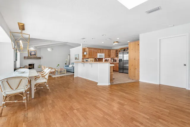 a view of a kitchen with dining room and wooden floor