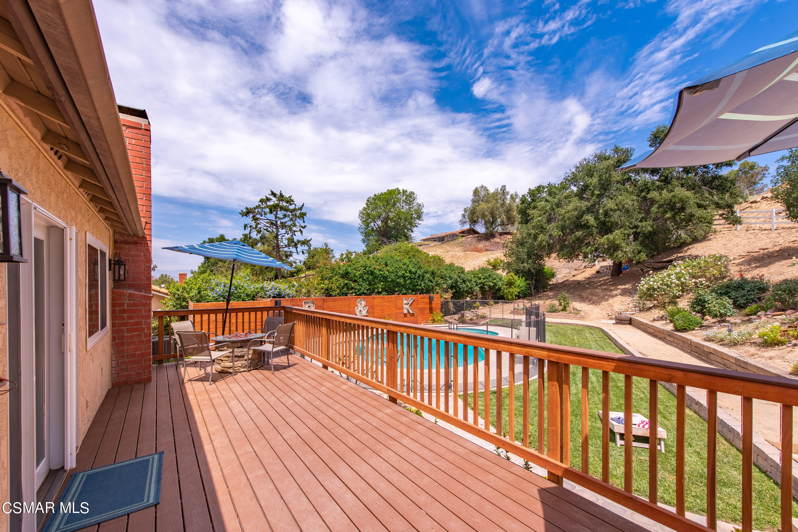 1137 Rambling Road Simi Valley, CA 93065 - Photo 31 of 77 a view of a balcony with wooden floor and outdoor seating