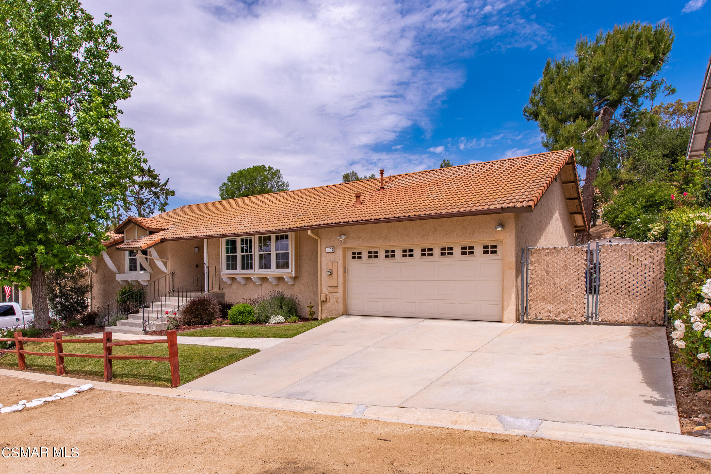1137 Rambling Road Simi Valley, CA 93065 - Photo 4 of 77 a front view of a house with a garden