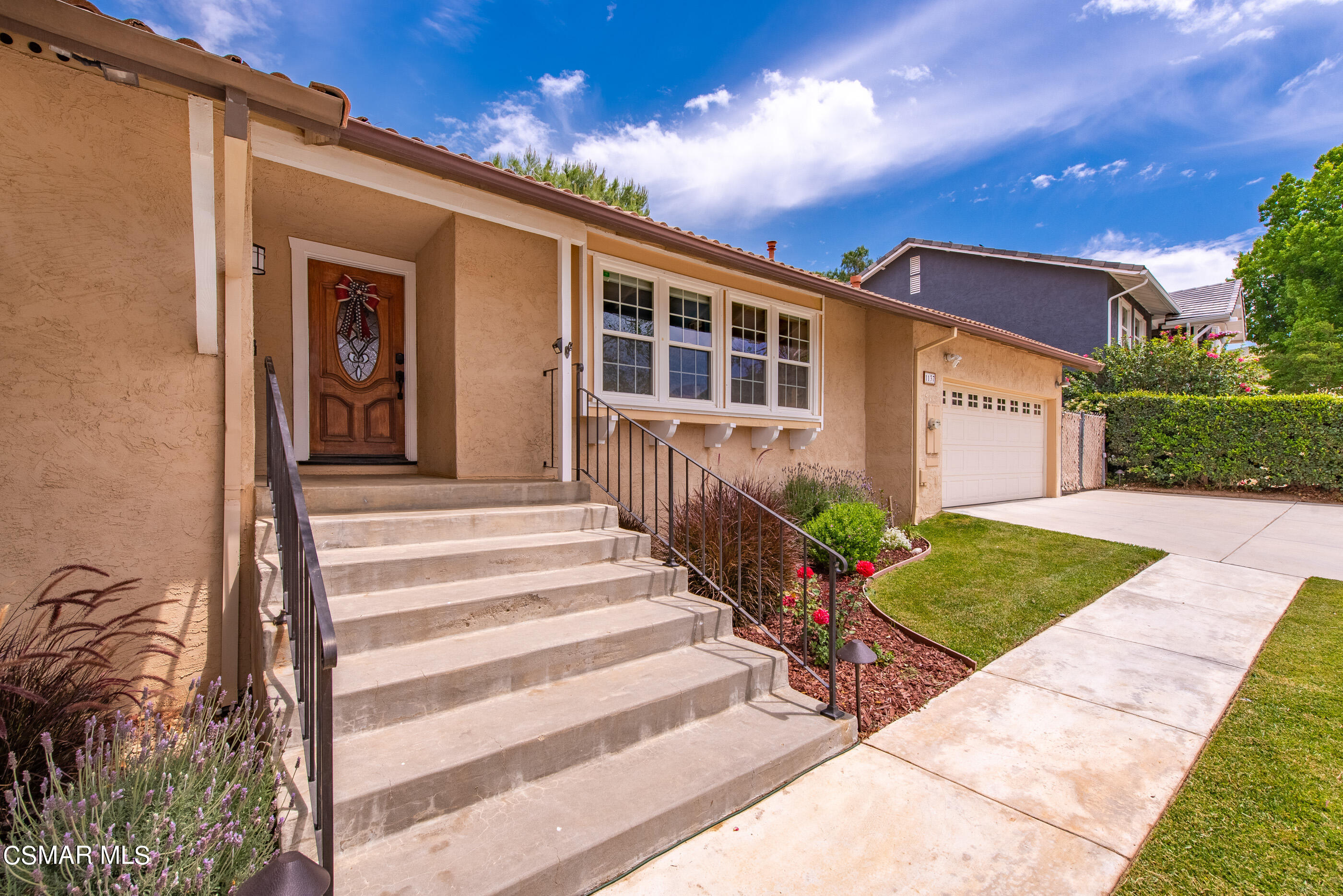 1137 Rambling Road Simi Valley, CA 93065 - Photo 5 of 77 a front view of a house with a yard and potted plants