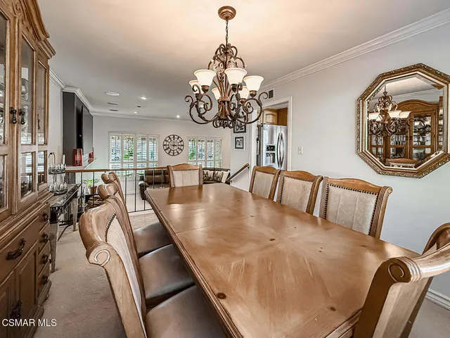 a view of a dining room with furniture and chandelier