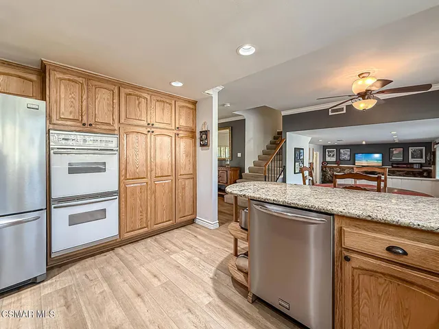 a kitchen with granite countertop a refrigerator and a sink