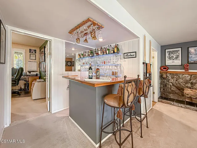 a living room with furniture and a pool table