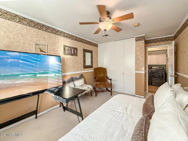 a bedroom with a large bed and a tv