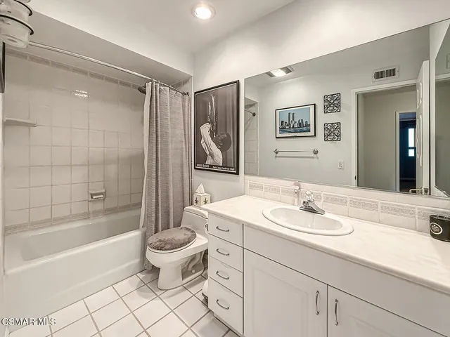 a bedroom with a bed a couch and dresser