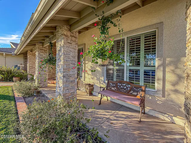 a bench sitting in front of a house