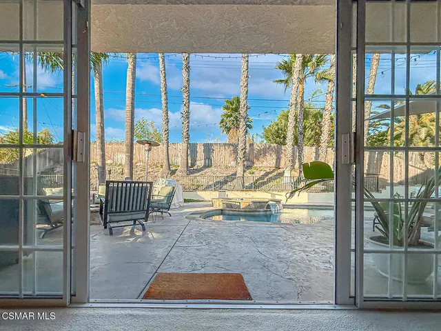 a view of a swimming pool with sitting area