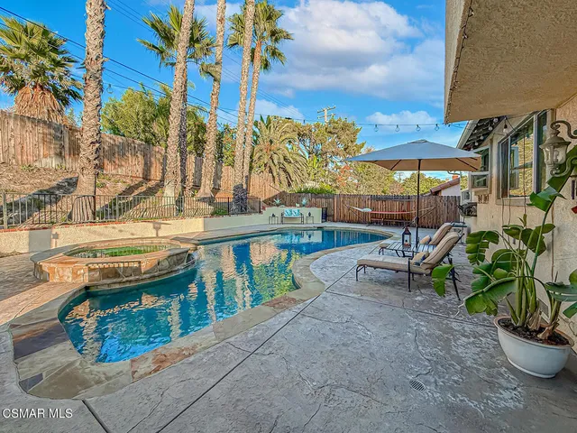 a house view with a sitting space and garden