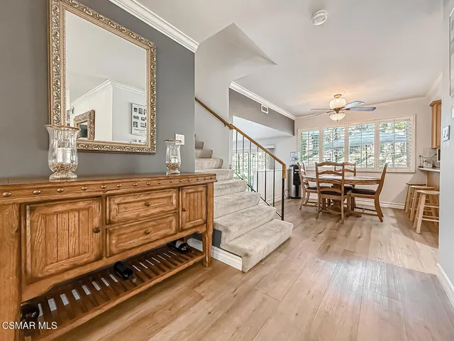 a living room with furniture a wooden floor and next to a window