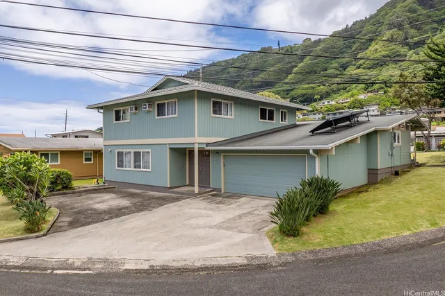 a front view of a house with a garden