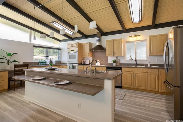 a kitchen with stainless steel appliances granite countertop lots of counter top space and furniture