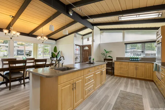 a kitchen with stainless steel appliances granite countertop sink stove and large window
