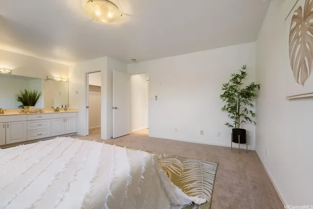 a view of a bedroom with wooden floor and windows
