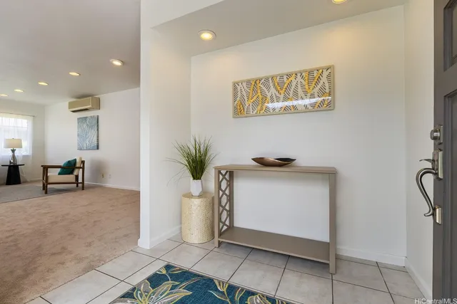 a view of a hallway with workspace and a window