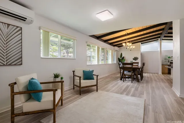 a dining room with furniture and wooden floor