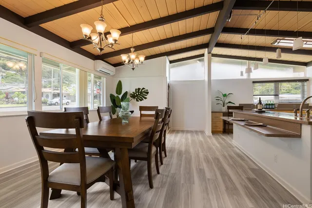 a view of a dining room with furniture wooden floor and chandelier