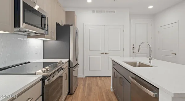 a kitchen with a sink stove and refrigerator