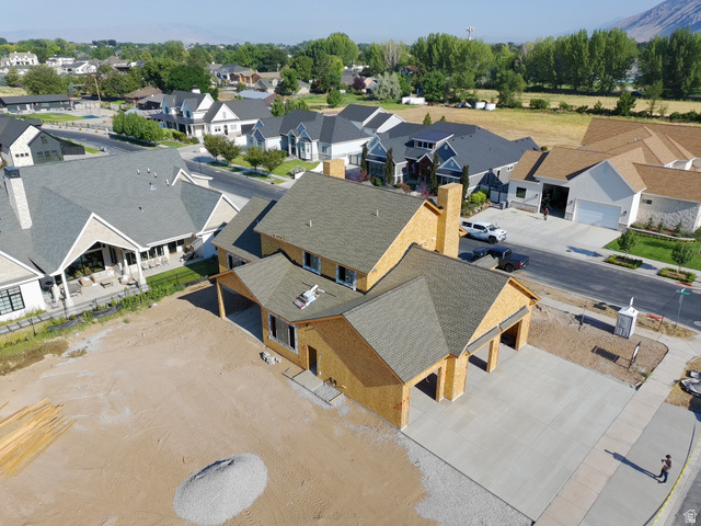 Newly constructed residence with a two-car garage, covered entry, and a prominent chimney feature