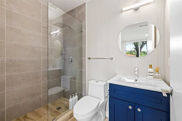 a bathroom with a toilet a sink and mirror