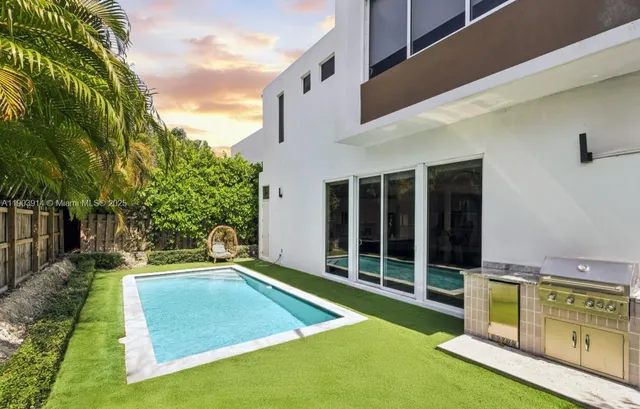 a view of an house with backyard space and swimming pool