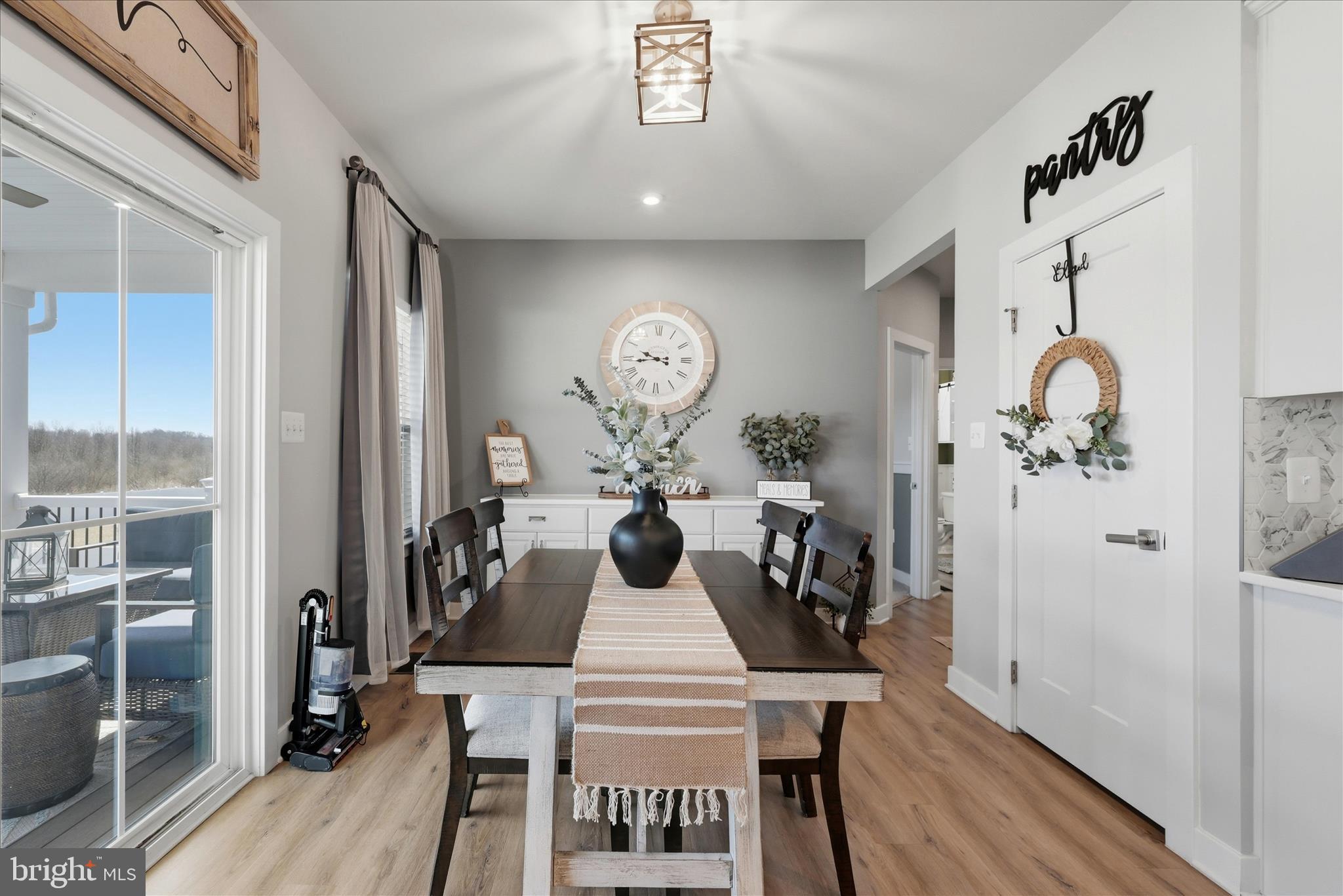 111 Decatur Circle Stephens City, VA 22655 - Photo 20 of 70 a view of a dining room with furniture a chandelier and wooden floor