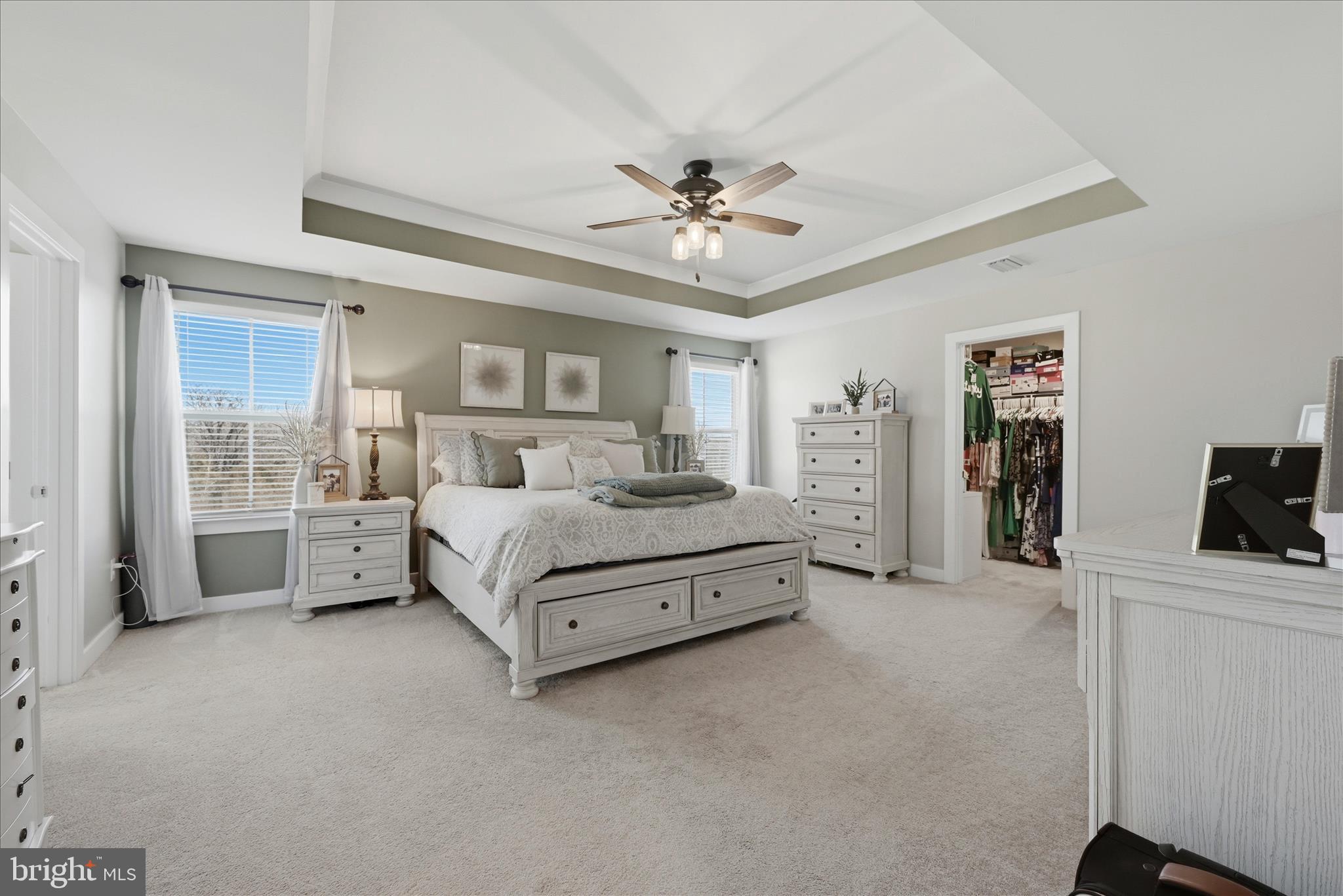 111 Decatur Circle Stephens City, VA 22655 - Photo 30 of 70 a spacious bedroom with a bed a couch and a ceiling fan