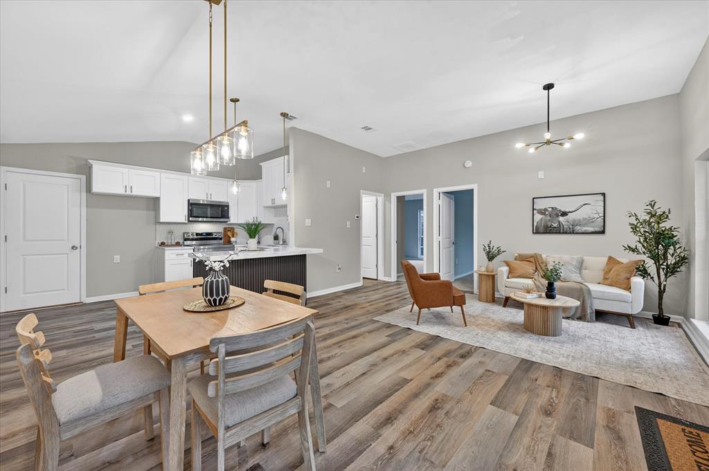 538 Pemberton Hill Road Dallas, TX 75217 - Photo 1 of 31 Open-concept living space featuring wood-finish flooring, vaulted ceilings, and recessed lighting