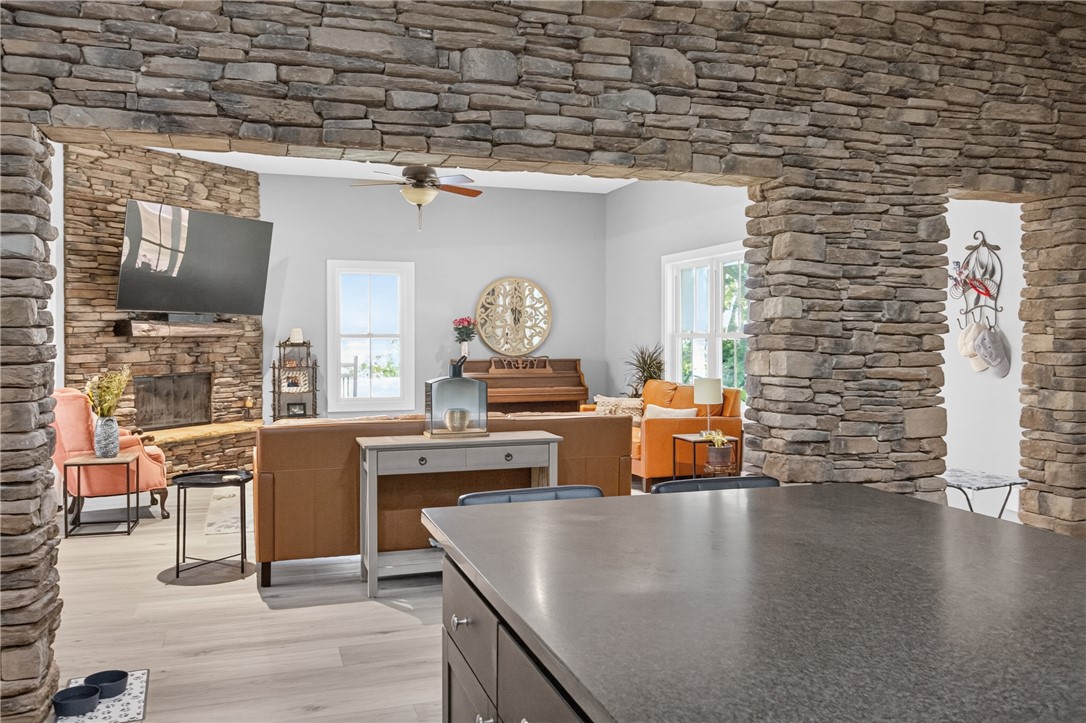 1504 Double Springs Road Townville, SC 29689 - Photo 10 of 49 Dramatic stone archways frame a view of the light-filled living area and fireplace.