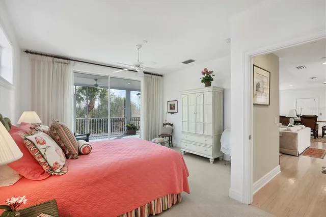 a living room with furniture a wooden floor and a chandelier