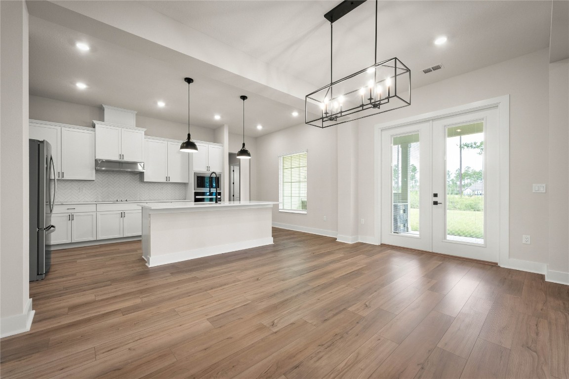 36199 Pitch Lane Hilliard, FL 32046 - Photo 14 of 40 a view of a kitchen with wooden floor and a window