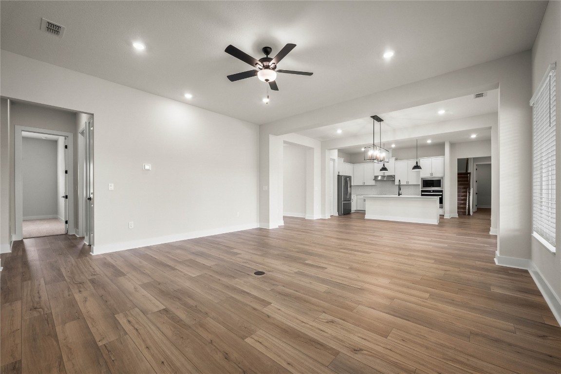 36199 Pitch Lane Hilliard, FL 32046 - Photo 17 of 40 a view of empty room with wooden floor and a ceiling fan