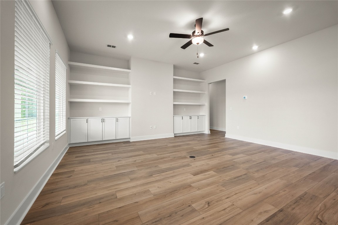 36199 Pitch Lane Hilliard, FL 32046 - Photo 21 of 40 a view of empty room with wooden floor and fan