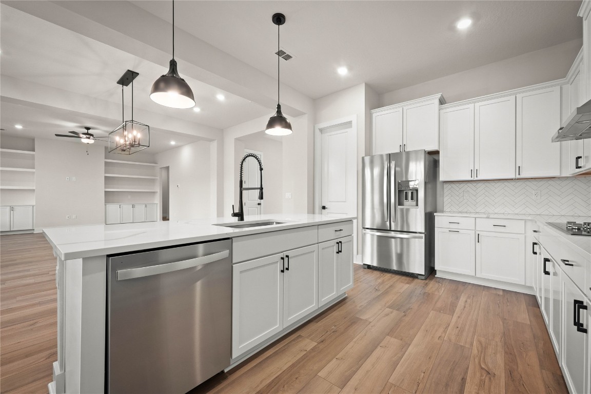 36199 Pitch Lane Hilliard, FL 32046 - Photo 25 of 40 a kitchen with stainless steel appliances a refrigerator sink and cabinets