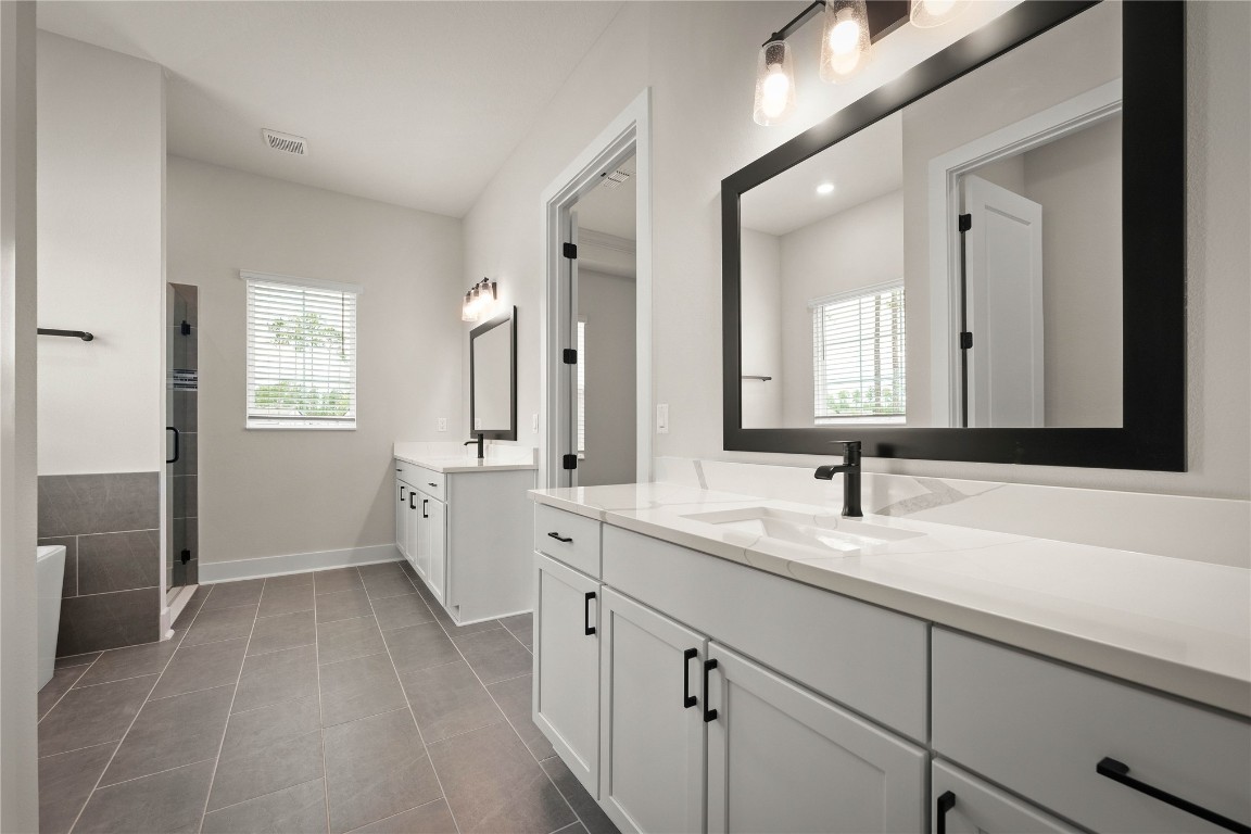 36199 Pitch Lane Hilliard, FL 32046 - Photo 31 of 40 a bathroom with a double vanity sink and mirror