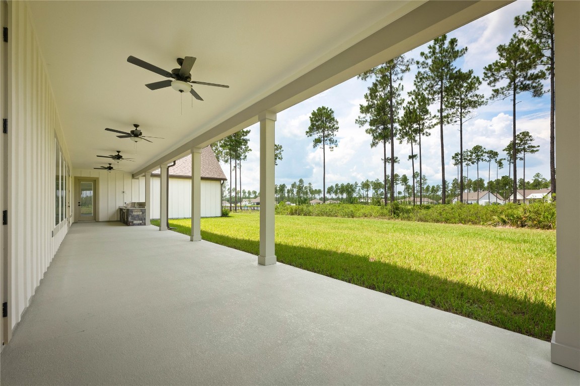 36199 Pitch Lane Hilliard, FL 32046 - Photo 36 of 40 a view of a house with a big yard and palm trees