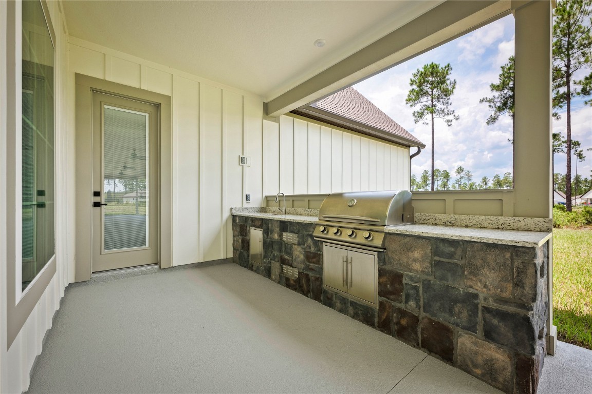 36199 Pitch Lane Hilliard, FL 32046 - Photo 39 of 40 a kitchen with stainless steel appliances granite countertop a stove and a sink