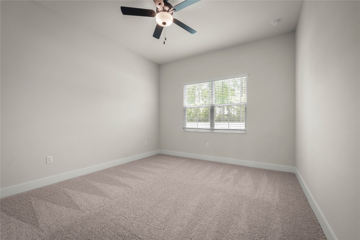 36199 Pitch Lane Hilliard, FL 32046 - Photo 8 of 40 an empty room with a window and a fan